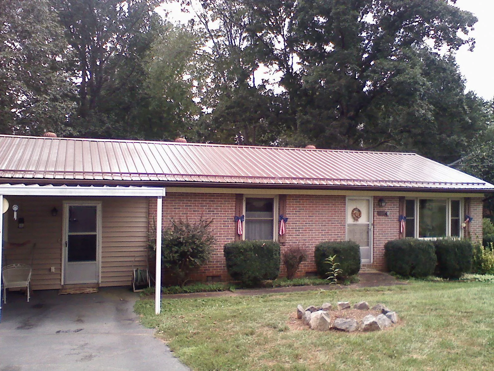 Bronze metal roof and carport on a brick ranch home — Roof Repair work by our crew in Lake Arrowhead
